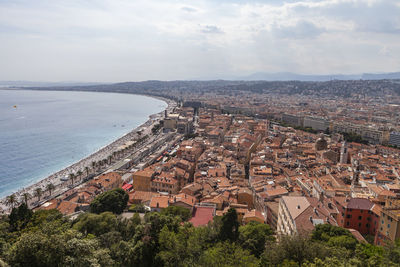 High angle view of townscape by sea against sky