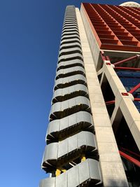 Low angle view of modern building against clear blue sky