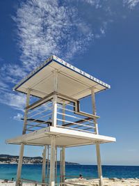 Low angle view of lifeguard hut on beach against sky