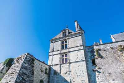 Low angle view of building against clear blue sky