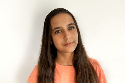 Portrait of girl standing against wall