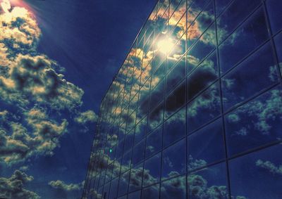 Low angle view of illuminated building against blue sky