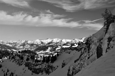 Scenic view of snow covered mountains against sky