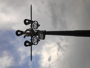 Low angle view of silhouette street light against sky