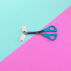 High angle view of pink umbrella against blue background