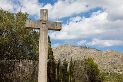 Low angle view of cross against mountain