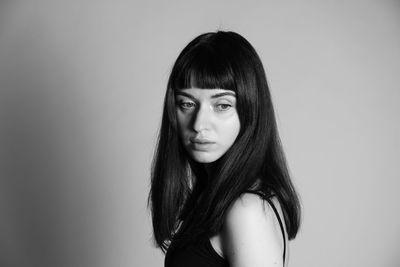 Portrait of a beautiful young woman against white background