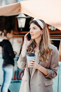 A girl with a bandage on her head speaks on the phone. portrait of a young woman