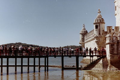 People at temple against clear sky