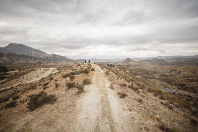 Scenic view of mountains against cloudy sky