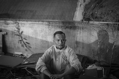 Portrait of young man sitting outdoors