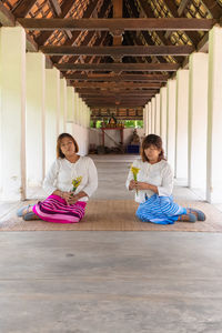 Woman sitting on wooden floor