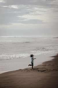 Young girl dancing on the beach