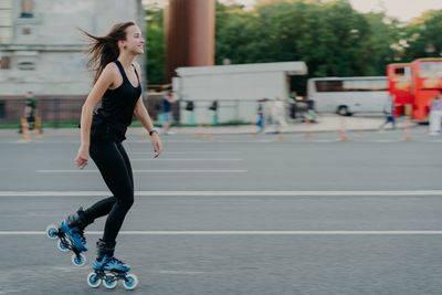 Full length of woman on skateboard