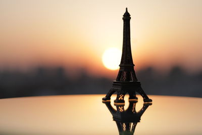 Close-up of silhouette tower against sky during sunset