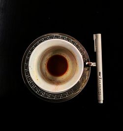 Directly above shot of coffee on table against black background