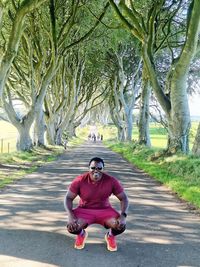 Side view of woman sitting on road