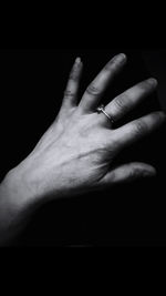 Close-up of woman hand over black background