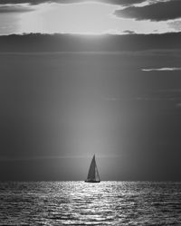 Sailboat sailing on sea against sky