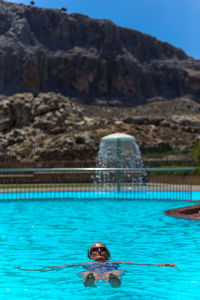 Portrait of man swimming in pool