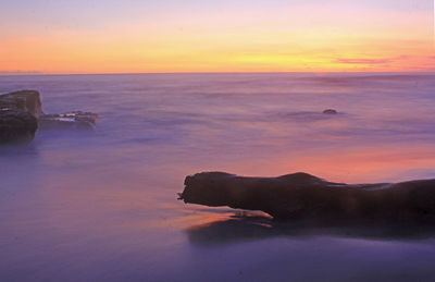 Scenic view of sea against sky at sunset