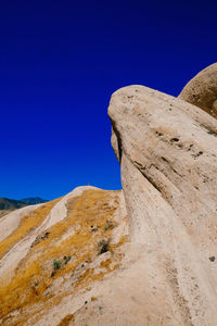 Scenic view of mountains against clear blue sky