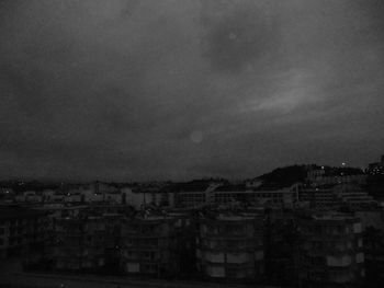 Buildings against cloudy sky