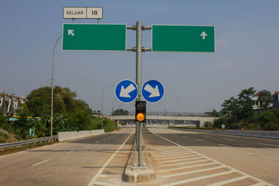 Road sign against blue sky