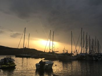 Sailboats in marina at sunset