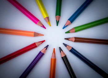 High angle view of colored pencils on white table