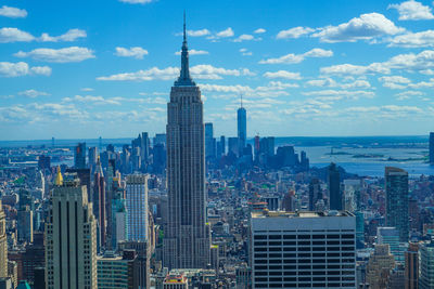 Modern buildings in city against cloudy sky