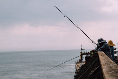 People fly-fishing in sea