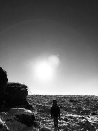 Rear view of silhouette man looking at sea against sky