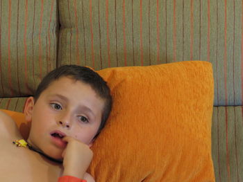 Portrait of cute baby relaxing on sofa at home