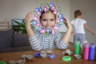 Portrait of cute girl playing with toys on table