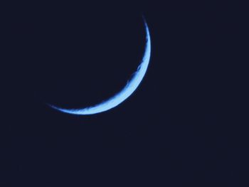 Low angle view of moon in sky at night