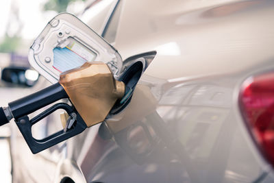 Close-up of pump filling fuel in car