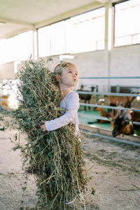Portrait of smiling young woman standing on field