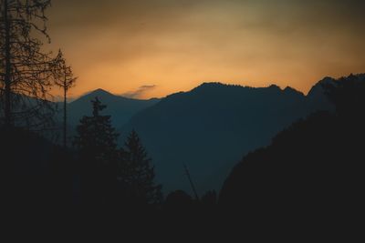 Scenic view of silhouette mountains against sky at sunset