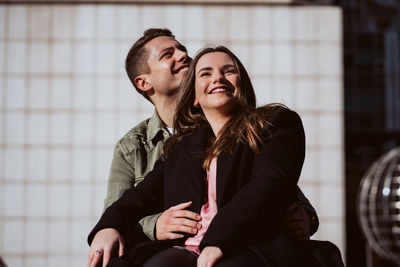 Young couple sitting outdoors
