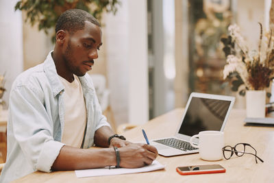 Businesswoman using laptop at office