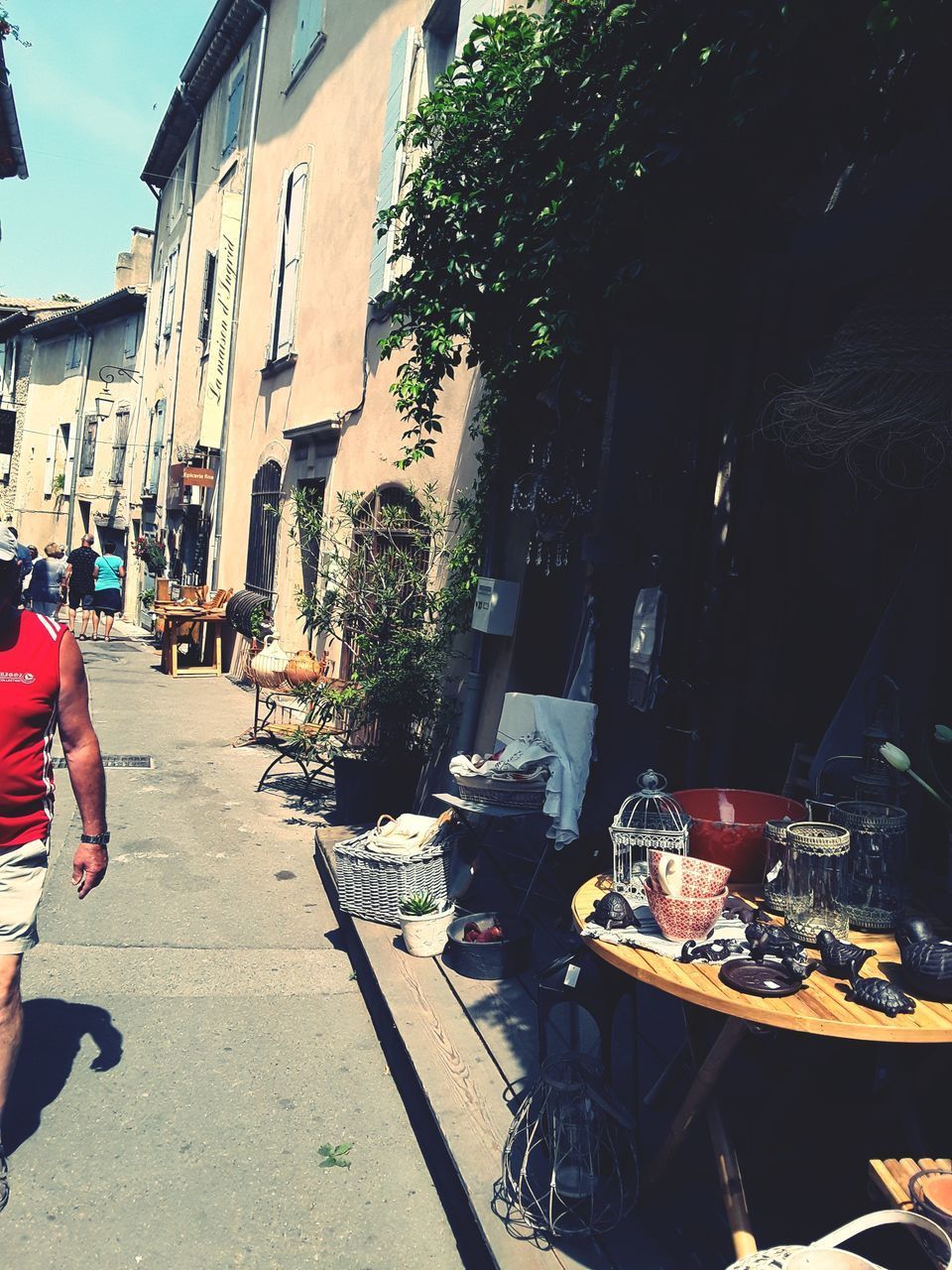 PEOPLE ON STREET AMIDST BUILDINGS