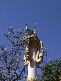 Low angle view of statue against clear blue sky