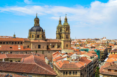 High angle view of buildings in town against sky