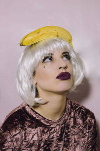 Portrait of woman with banana on head