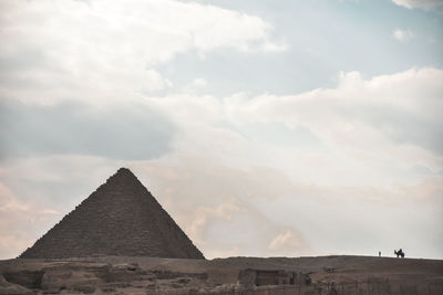 Low angle view of historical building against cloudy sky