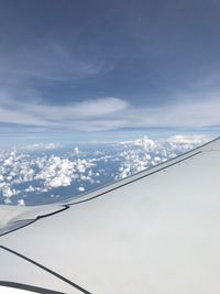 Low angle view of airplane flying against sky