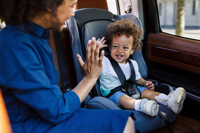 Mother with son sitting in car