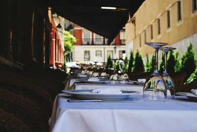 Wineglasses and plates arranged on dinning table