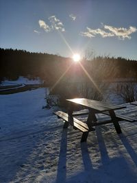 Scenic view of snow field against sky during winter